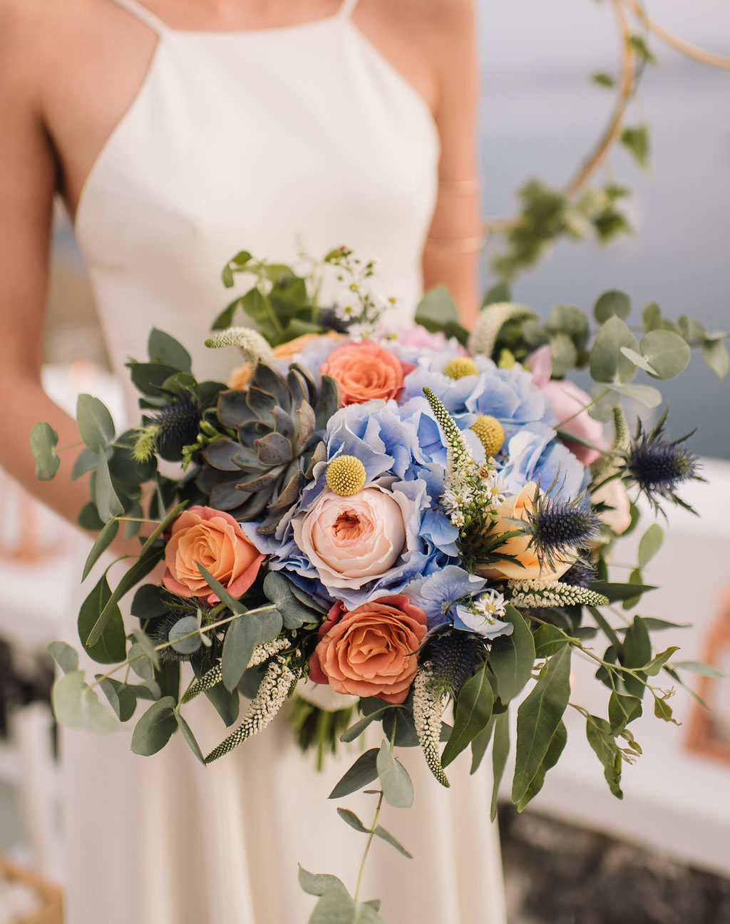 Dusty blue and peach bridal bouquet 
