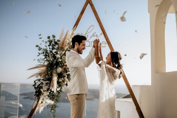 Bohemian & modern wedding in Santorini- triangle arch