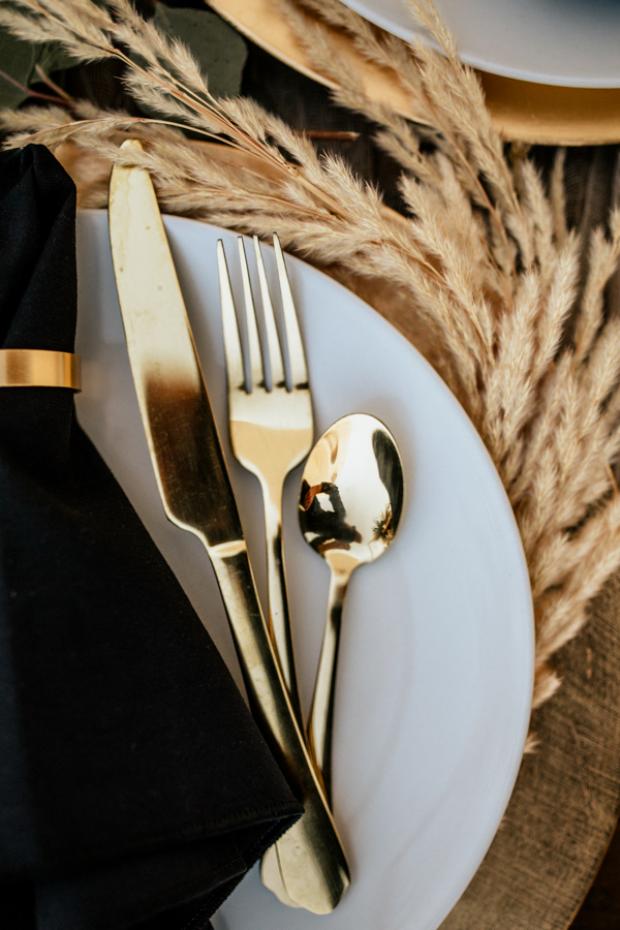 Bohemian and modern wedding dinner- gold and black